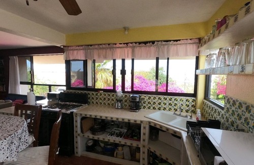 Mauricio Castro House | Large house on a hill with a spectacular view over the sea and mountains