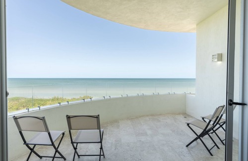 Miramar Apartment | Beachfront apartment with private balcony, heated pool & stunning views