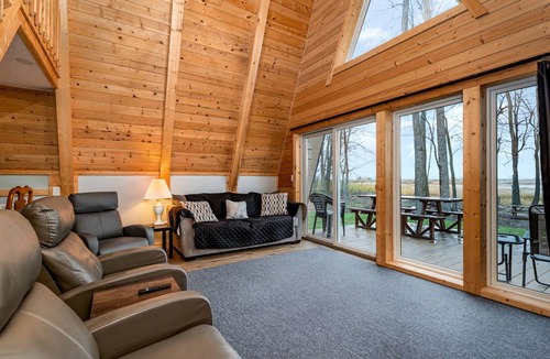 Au Gres Cabin | Lofted A-Frame Cabin with Direct Lake Access and Equipped Deck in Michigan