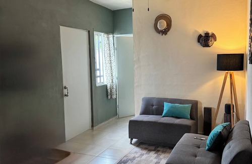 Cancun House | MiniHouse in front of park with parking.