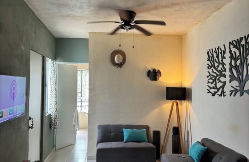 Cancun House | MiniHouse in front of park with parking.