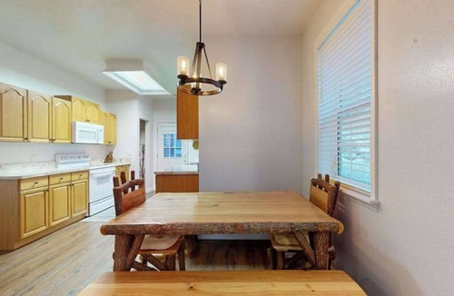 Sylva House | Mountain view home with a fireplace with beautiful view of the creek