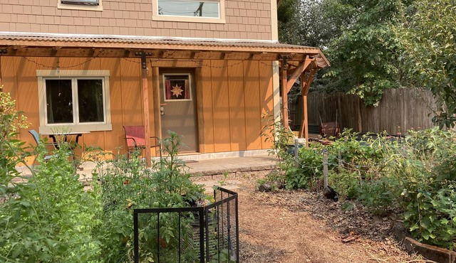 Custom Built Tiny House in an organic backyard garden