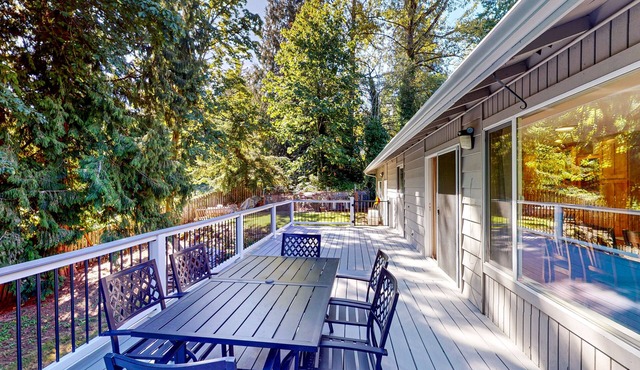 Dog-friendly home with large yard, inviting deck & spacious layout